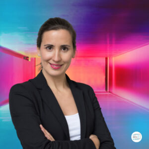 Andreia Fernandes in a Portrait with black suit in Front of her colored PFC® Portfolio Career Wall